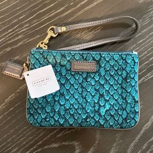 New with tags. Never used. Green/teal snake skin coach wristlet.